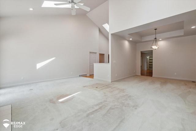 8078 Hawkcrest Dr, Grand Blanc, MI 48439 - unfurnished room featuring a skylight, light carpet, ceiling fan, recessed lighting, and a high ceiling
