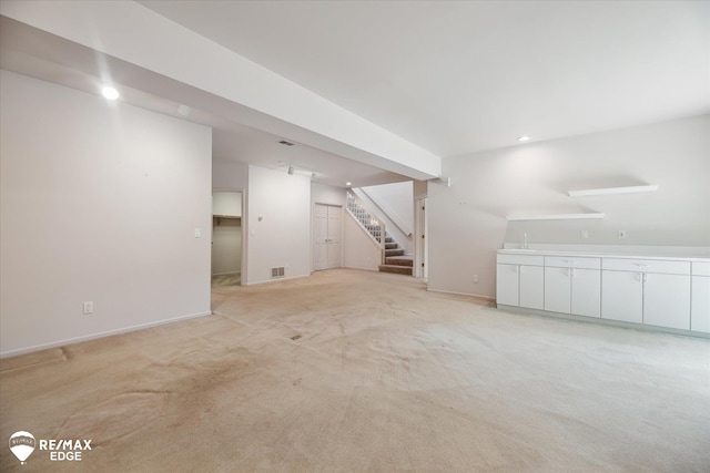 8078 Hawkcrest Dr, Grand Blanc, MI 48439 - below grade area with stairs, light carpet, recessed lighting, and bar area