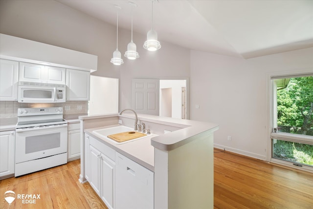 8078 Hawkcrest Dr, Grand Blanc, MI 48439 - kitchen featuring lofted ceiling, white appliances, light countertops, light wood-type flooring, and backsplash