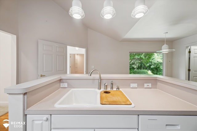 8078 Hawkcrest Dr, Grand Blanc, MI 48439 - kitchen with light countertops, white cabinetry, hanging light fixtures, and lofted ceiling