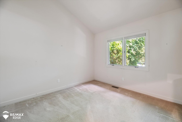 8078 Hawkcrest Dr, Grand Blanc, MI 48439 - spare room with light carpet and vaulted ceiling