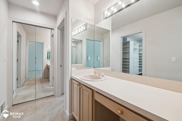 8078 Hawkcrest Dr, Grand Blanc, MI 48439 - bathroom with vanity, a walk in closet, and recessed lighting