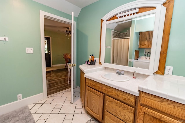 1193 Seneca St, Adrian, MI 49221 - bathroom featuring vanity, washer / dryer, ceiling fan, tile patterned floors, and curtained shower