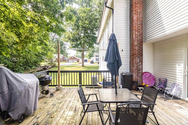 1193 Seneca St, Adrian, MI 49221 - wooden terrace featuring area for grilling, outdoor dining area, and a yard
