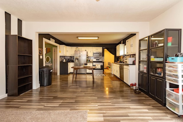 1193 Seneca St, Adrian, MI 49221 - kitchen with appliances with stainless steel finishes, dark wood-type flooring, dark countertops, and white cabinets