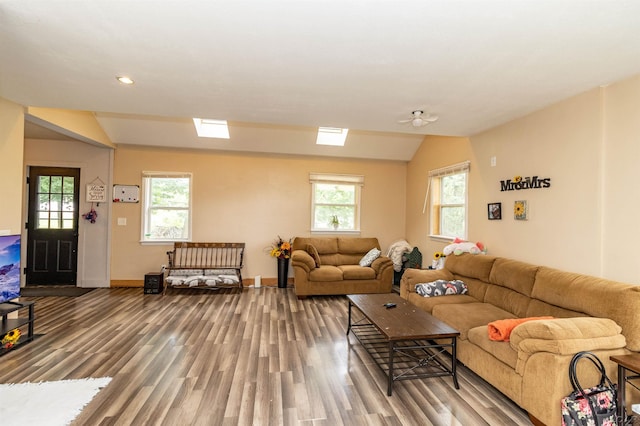 1193 Seneca St, Adrian, MI 49221 - living area featuring wood finished floors, plenty of natural light, vaulted ceiling, and recessed lighting