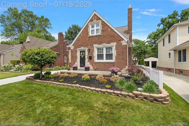 1816 Roslyn Rd, Grosse Pointe Woods, MI 48236 - english style home featuring brick siding, a front yard, and a chimney
