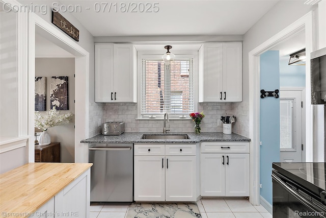 1816 Roslyn Rd, Grosse Pointe Woods, MI 48236 - kitchen featuring light tile patterned flooring, stainless steel dishwasher, white cabinets, and decorative backsplash