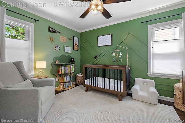 1816 Roslyn Rd, Grosse Pointe Woods, MI 48236 - bedroom with a nursery area, wood finished floors, ornamental molding, and a ceiling fan
