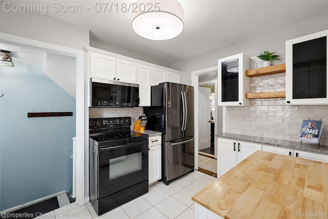 1816 Roslyn Rd, Grosse Pointe Woods, MI 48236 - kitchen featuring black range with electric stovetop, stainless steel microwave, backsplash, white cabinetry, and light tile patterned flooring