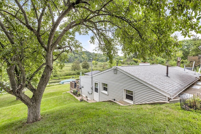 11585 Onsted Hwy, Brooklyn, MI 49230 - view of property exterior featuring roof with shingles, a chimney, and a yard