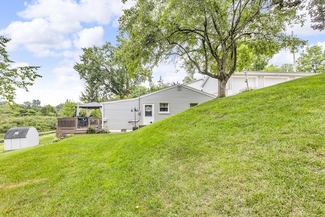 11585 Onsted Hwy, Brooklyn, MI 49230 - view of green lawn featuring a storage unit and a wooden deck