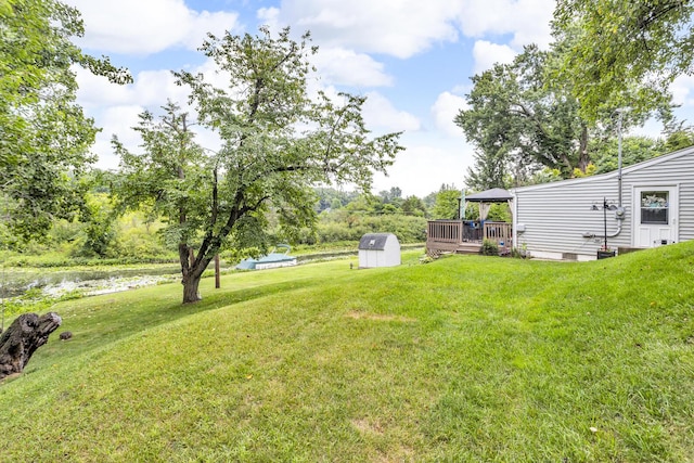 11585 Onsted Hwy, Brooklyn, MI 49230 - view of grassy yard with a gazebo, a deck with water view, and a storage shed