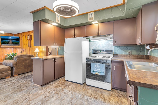 11585 Onsted Hwy, Brooklyn, MI 49230 - kitchen with white appliances, wood walls, open floor plan, and under cabinet range hood