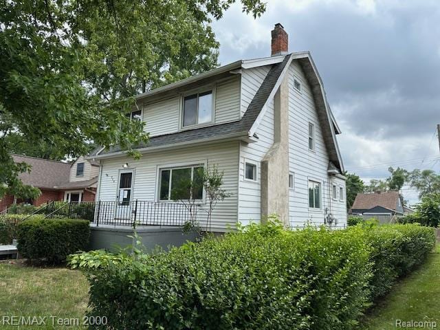 214 E Hazelhurst St, Ferndale, MI 48220 - view of front of home with a gambrel roof, roof with shingles, and a chimney