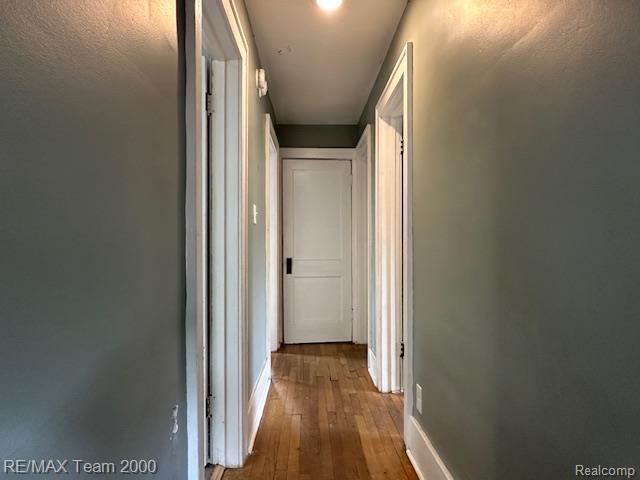 214 E Hazelhurst St, Ferndale, MI 48220 - hallway with wood-type flooring and baseboards