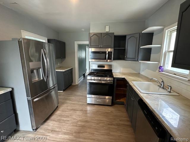 214 E Hazelhurst St, Ferndale, MI 48220 - kitchen featuring stainless steel appliances, open shelves, light countertops, and gray cabinets
