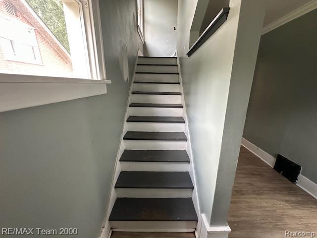 214 E Hazelhurst St, Ferndale, MI 48220 - staircase featuring wood finished floors and crown molding