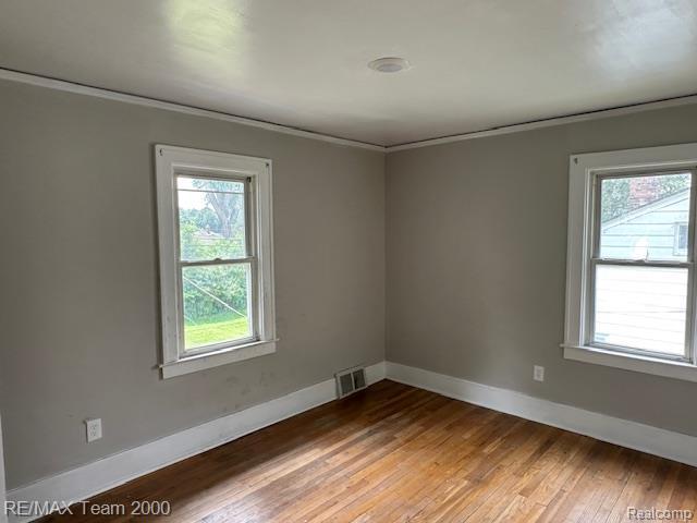 214 E Hazelhurst St, Ferndale, MI 48220 - unfurnished room featuring light wood-style floors and crown molding