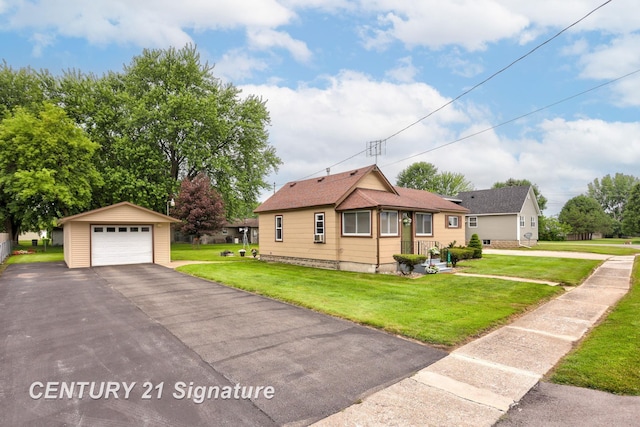 209 3rd St, Linwood, MI 48634 - view of front facade with an outdoor structure, a detached garage, a front lawn, and driveway
