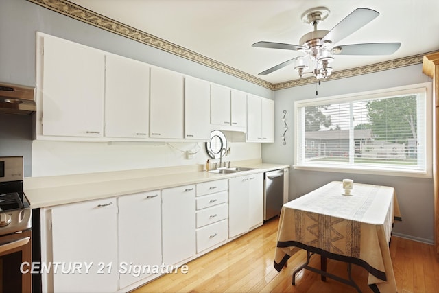 209 3rd St, Linwood, MI 48634 - kitchen with light wood-style flooring, stainless steel appliances, white cabinets, and a ceiling fan