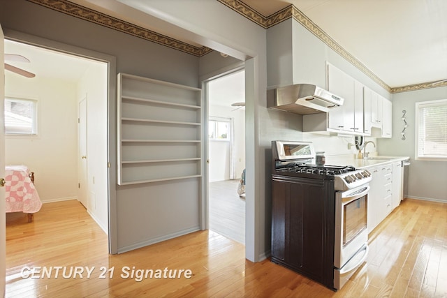 209 3rd St, Linwood, MI 48634 - kitchen with stainless steel appliances, white cabinets, light wood-type flooring, and crown molding