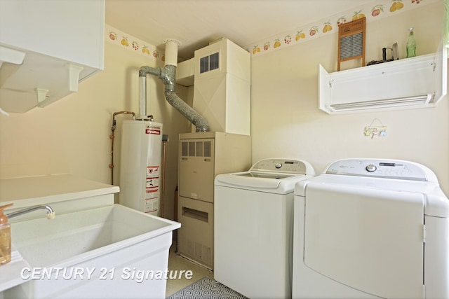 209 3rd St, Linwood, MI 48634 - washroom with washer and clothes dryer, heating unit, and gas water heater