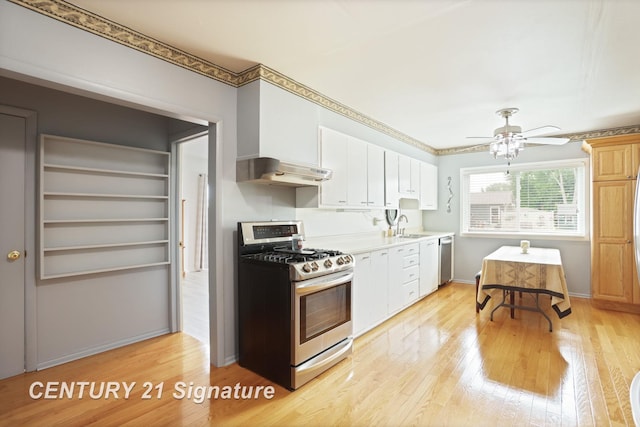 209 3rd St, Linwood, MI 48634 - kitchen featuring appliances with stainless steel finishes, light countertops, light wood-style floors, extractor fan, and white cabinets
