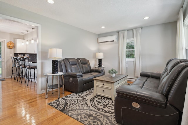 10999 M 140, Niles, MI 49120 - living room with light wood finished floors, recessed lighting, a wall mounted AC, a textured ceiling, and a baseboard heating unit
