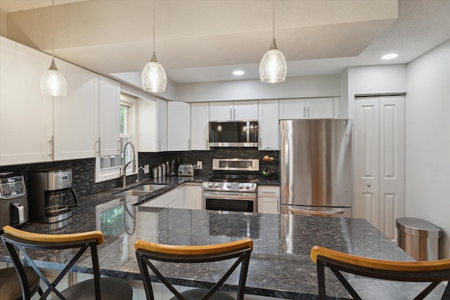 10999 M 140, Niles, MI 49120 - kitchen featuring stainless steel appliances, decorative backsplash, white cabinets, hanging light fixtures, and recessed lighting