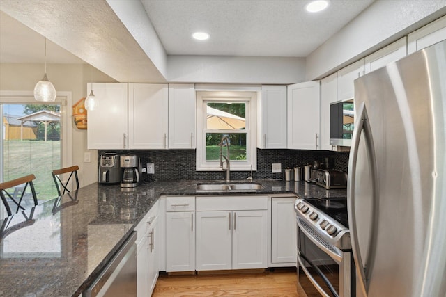 10999 M 140, Niles, MI 49120 - kitchen with appliances with stainless steel finishes, white cabinetry, backsplash, light wood-style flooring, and recessed lighting
