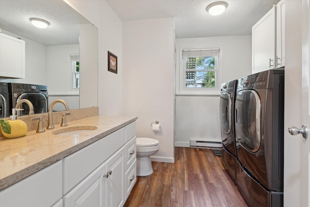10999 M 140, Niles, MI 49120 - laundry area featuring washer and clothes dryer, a textured ceiling, dark wood finished floors, and a baseboard radiator