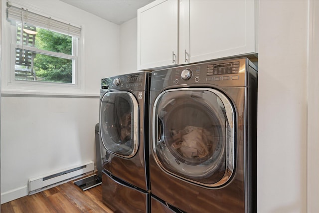 10999 M 140, Niles, MI 49120 - washroom featuring cabinet space, a baseboard radiator, washing machine and clothes dryer, and wood finished floors