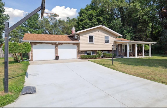 10999 M 140, Niles, MI 49120 - split level home with a chimney, covered porch, an attached garage, a front lawn, and concrete driveway