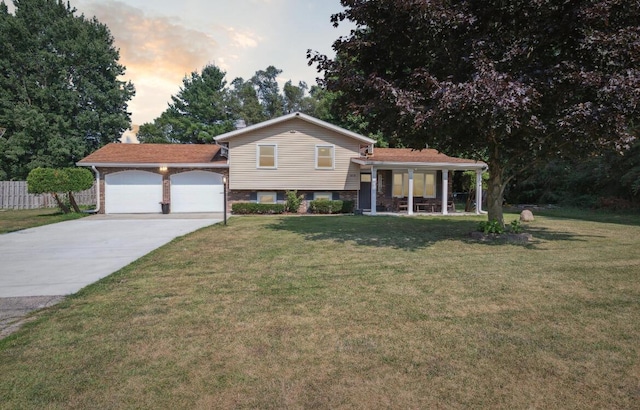 10999 M 140, Niles, MI 49120 - tri-level home with a garage, driveway, brick siding, and a porch