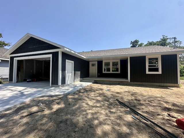 320 Wood St, Muskegon, MI 49442 - ranch-style home featuring an attached garage, covered porch, driveway, and roof with shingles