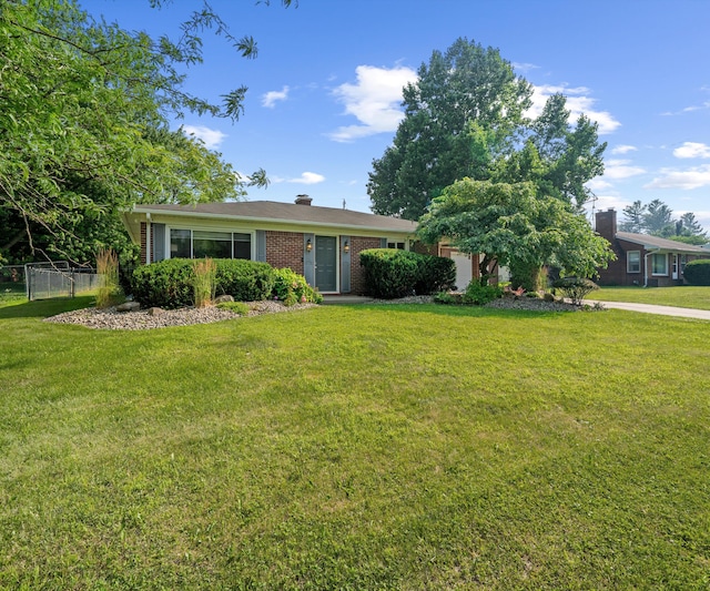 700 Devonshire Rd, Fowlerville, MI 48836 - ranch-style home featuring a chimney and brick siding