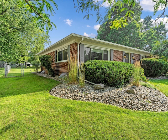700 Devonshire Rd, Fowlerville, MI 48836 - view of home's exterior with brick siding and a gate