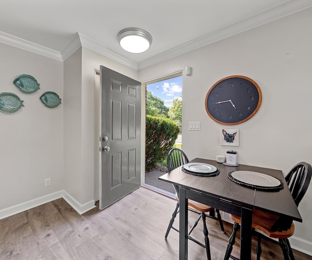 700 Devonshire Rd, Fowlerville, MI 48836 - dining room featuring light wood finished floors and ornamental molding