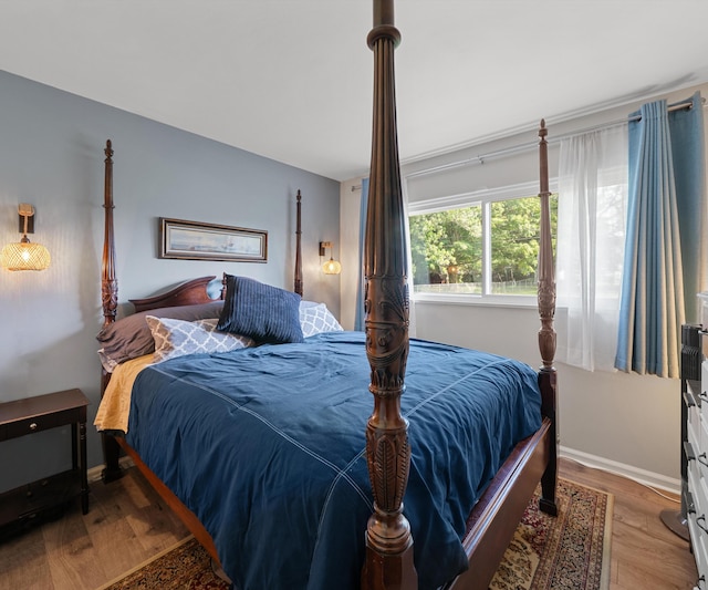 700 Devonshire Rd, Fowlerville, MI 48836 - bedroom featuring wood finished floors and baseboards