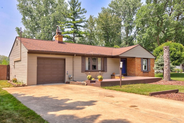 2113 Bock Rd, Saginaw, MI 48603 - single story home with a garage, roof with shingles, concrete driveway, and a chimney