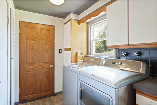 2113 Bock Rd, Saginaw, MI 48603 - washroom featuring cabinet space, separate washer and dryer, dark wood-type flooring, and ornamental molding