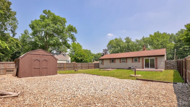 2113 Bock Rd, Saginaw, MI 48603 - rear view of property featuring a storage shed, a chimney, and a fenced backyard