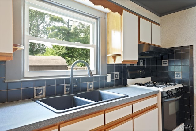 2113 Bock Rd, Saginaw, MI 48603 - kitchen with black range with gas stovetop, white cabinetry, under cabinet range hood, and backsplash