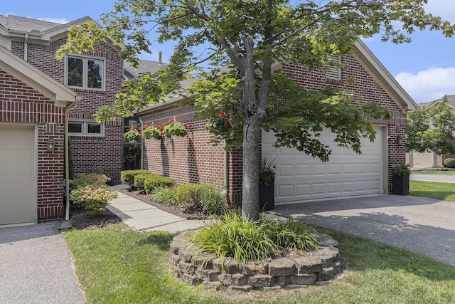 113 Ponds View Dr, Ann Arbor, MI 48103 - view of side of home featuring a garage, brick siding, and asphalt driveway