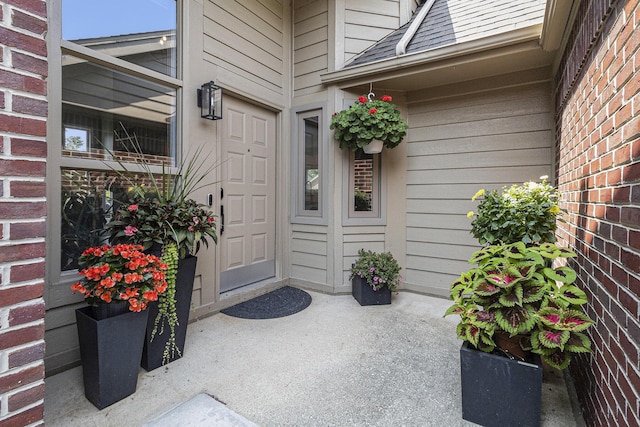 113 Ponds View Dr, Ann Arbor, MI 48103 - property entrance featuring a shingled roof and brick siding