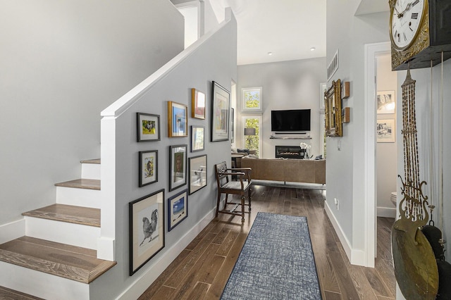 113 Ponds View Dr, Ann Arbor, MI 48103 - foyer entrance featuring stairs, dark wood-style flooring, a lit fireplace, and recessed lighting
