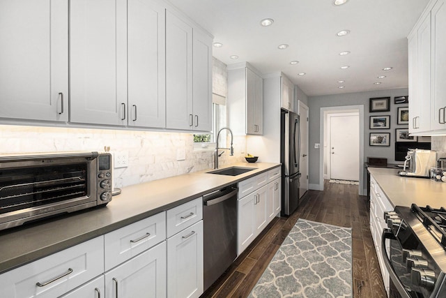 113 Ponds View Dr, Ann Arbor, MI 48103 - kitchen with appliances with stainless steel finishes, recessed lighting, backsplash, white cabinets, and dark wood-type flooring