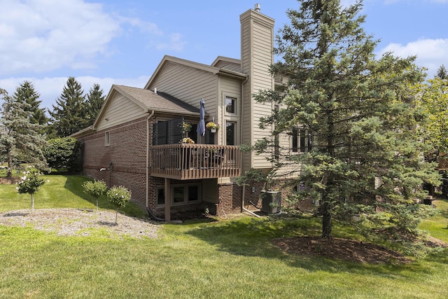 113 Ponds View Dr, Ann Arbor, MI 48103 - back of property with brick siding, a lawn, a chimney, and a wooden deck