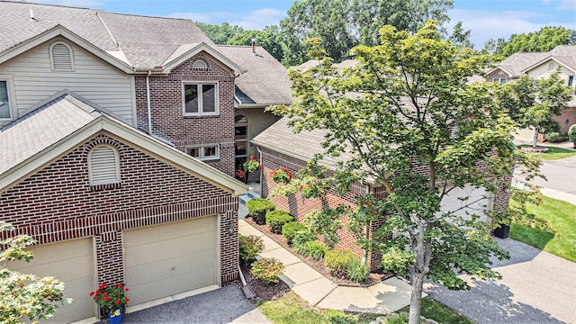 113 Ponds View Dr, Ann Arbor, MI 48103 - view of front of house featuring brick siding, a shingled roof, a garage, and driveway